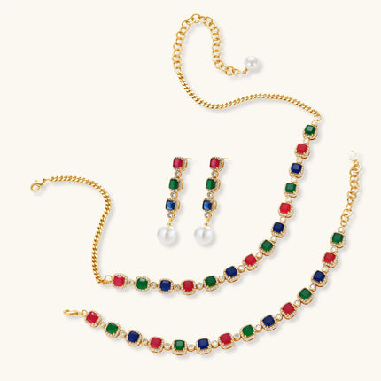 Gold-plated jewelry set with red, green, and blue cubic zirconia stones including necklace, bracelet, and drop earrings.