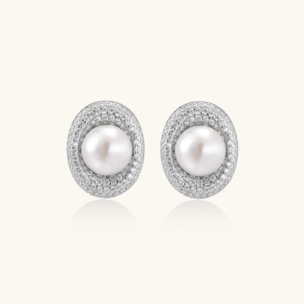 Elegant stud earrings with cream freshwater pearls surrounded by sparkly pavé crystals on rhodium-plated silver setting
