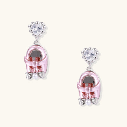 Pink translucent cage earrings with heart-shaped zirconia tops and pearl accents on white gold plated posts.