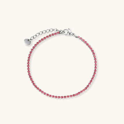 Pink zircon tennis bracelet with silver-tone stainless steel setting and lobster clasp extender chain, flat lay.