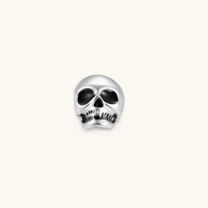 Matte silver skull stud earring with black enamel eye sockets and detailed teeth, post backing, 316L stainless steel.