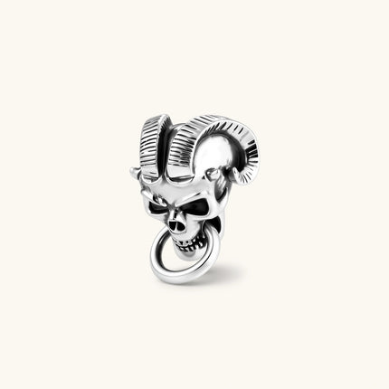 Silver 316L stainless steel stud earring shaped as a horned demon skull with ram horns and a dangling mouth ring.