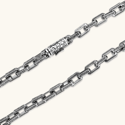Silver 316L stainless steel rectangular link chain necklace with intricate scroll engravings, 560mm length, 7.1mm width.